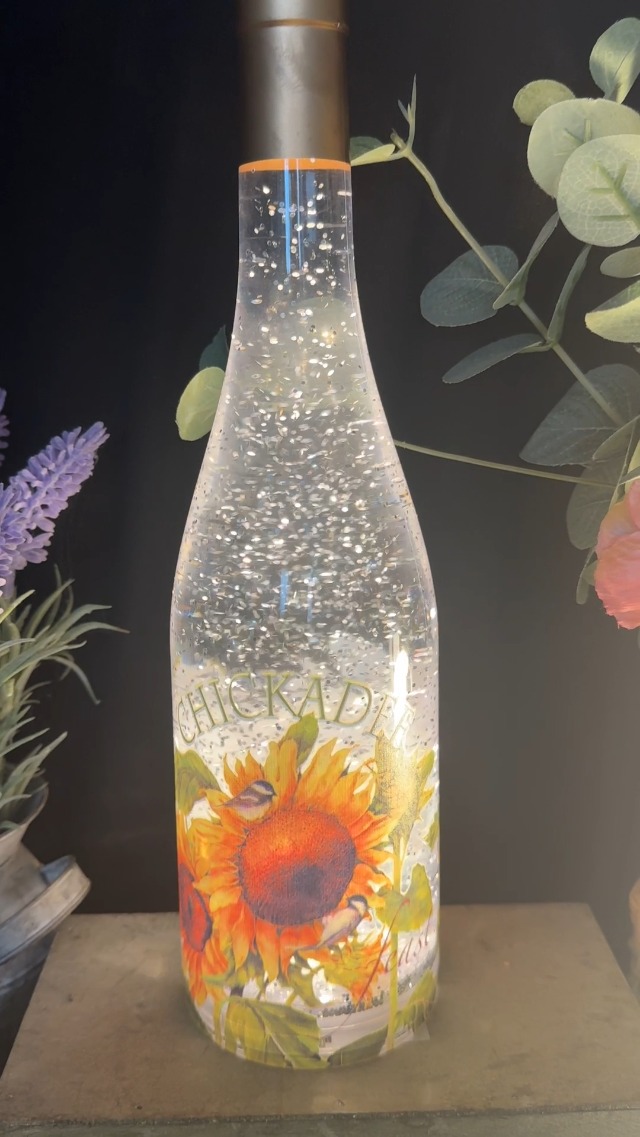 Watch Wine bottle lighted swirling snow globe with sunflowers on