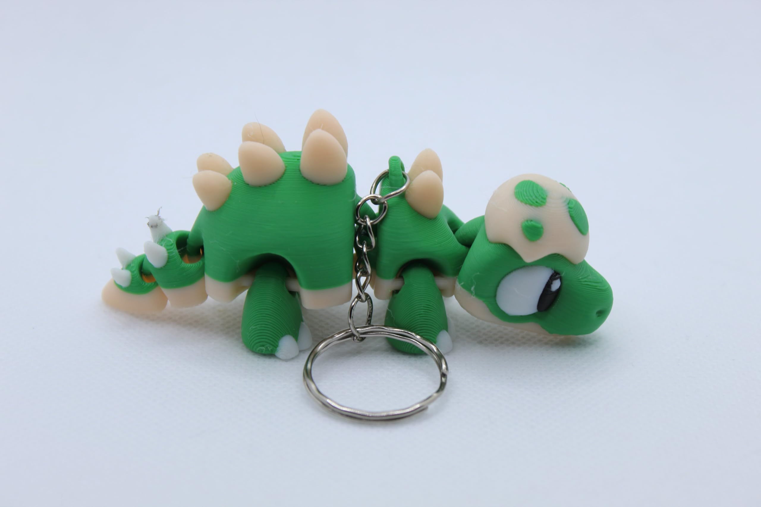 Stegosaurus Fidget Figurine with Egg – Dinosaur Sensory Toy for Stress Relief & Collectors (Keyring Version)