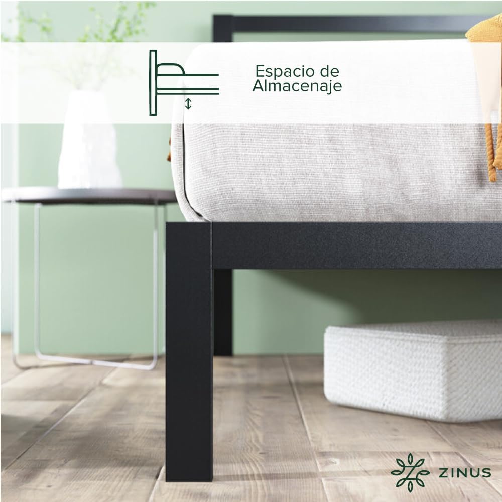 A close-up image showing a hand using a ratchet tool to tighten a bolt on a black metal bed frame connection point.