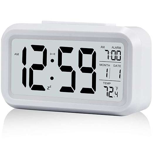 Digital Alarm Clock,Battery Operated Small Desk Clocks,with Date,Indoor Temperature,Smart Night Light,LCD Electronic Clock for Bedroom Home Office – White at Rs. 299