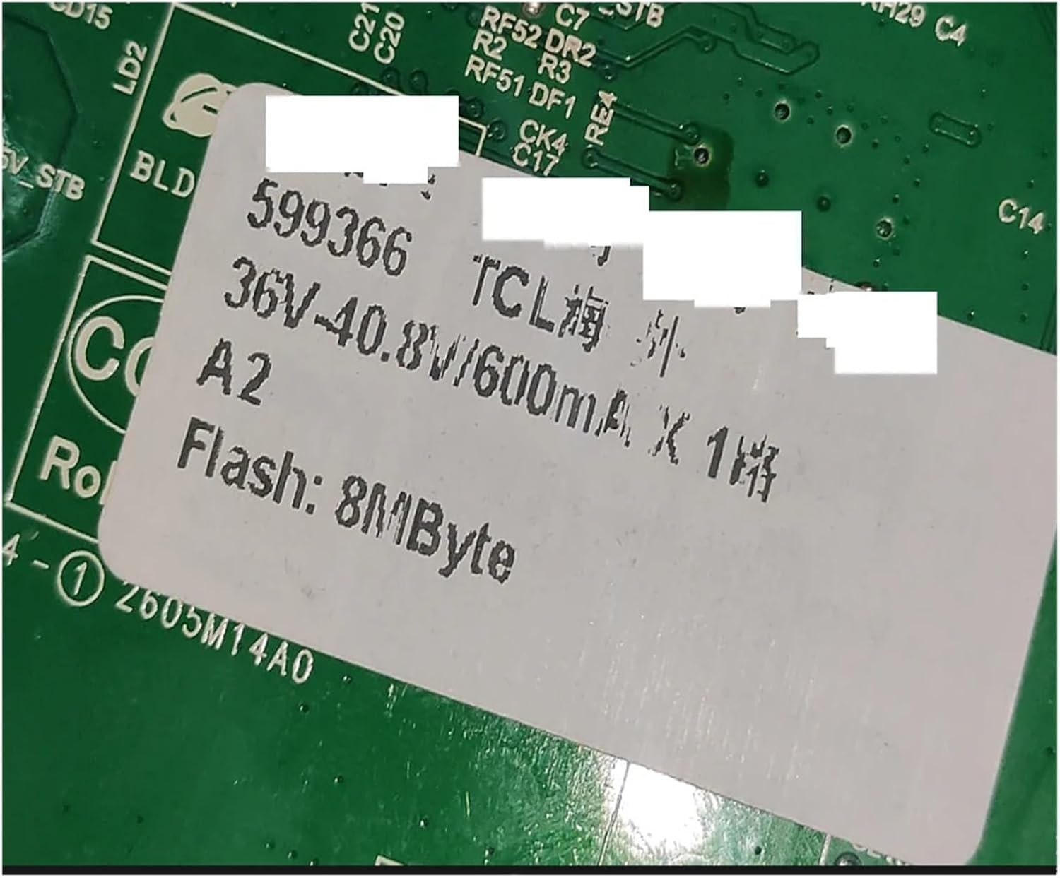 Close-up of a white sticker on the TV motherboard indicating specifications like 36V-40.8V/600mA and 8 MByte Flash memory.