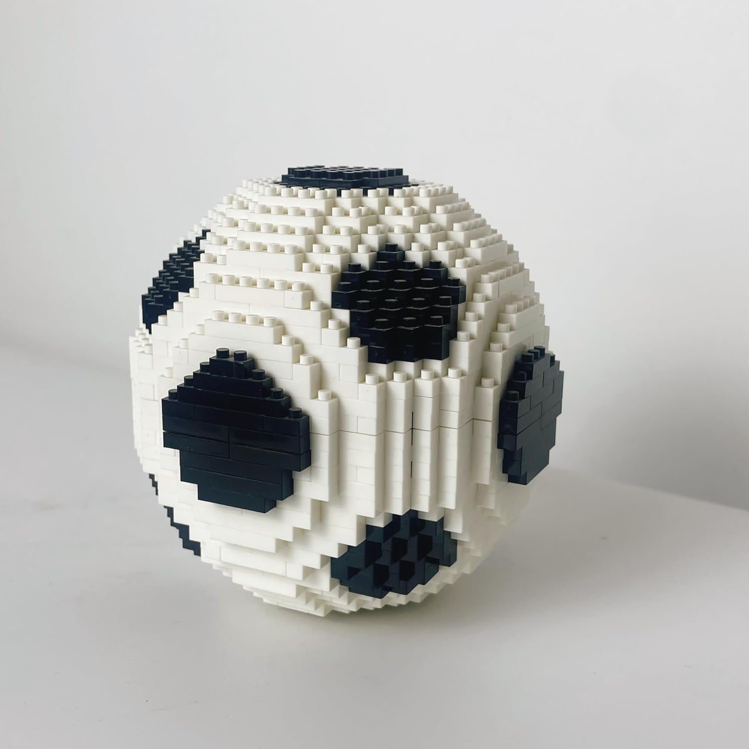 Close-up view of the assembled micro mini building block soccer ball, showing its black and white panel design.