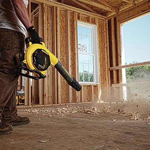 Man using DEWALT blower to clear wood chips from a construction site