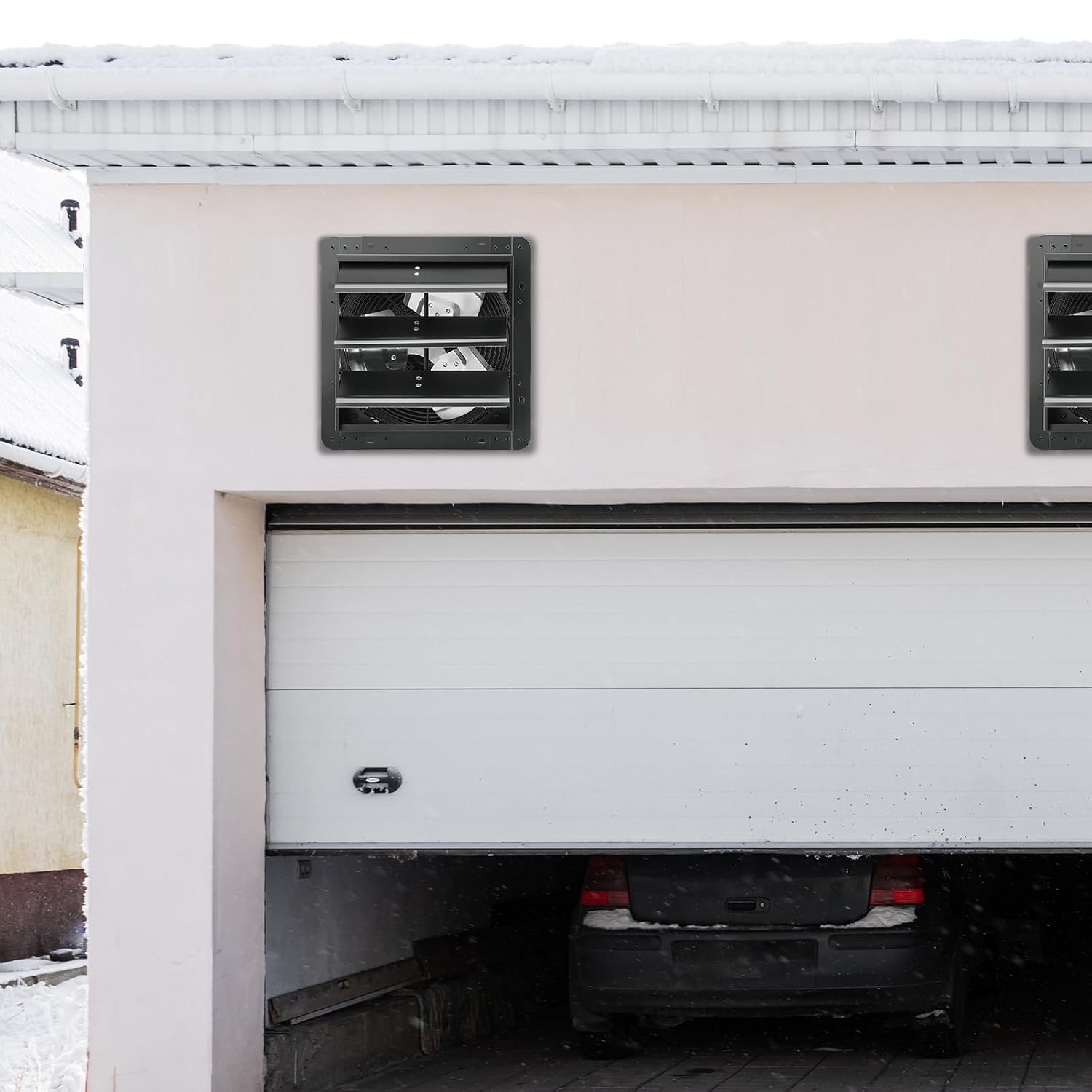VEVOR 12-inch EC Shutter Exhaust Fan installed in a garage wall during winter
