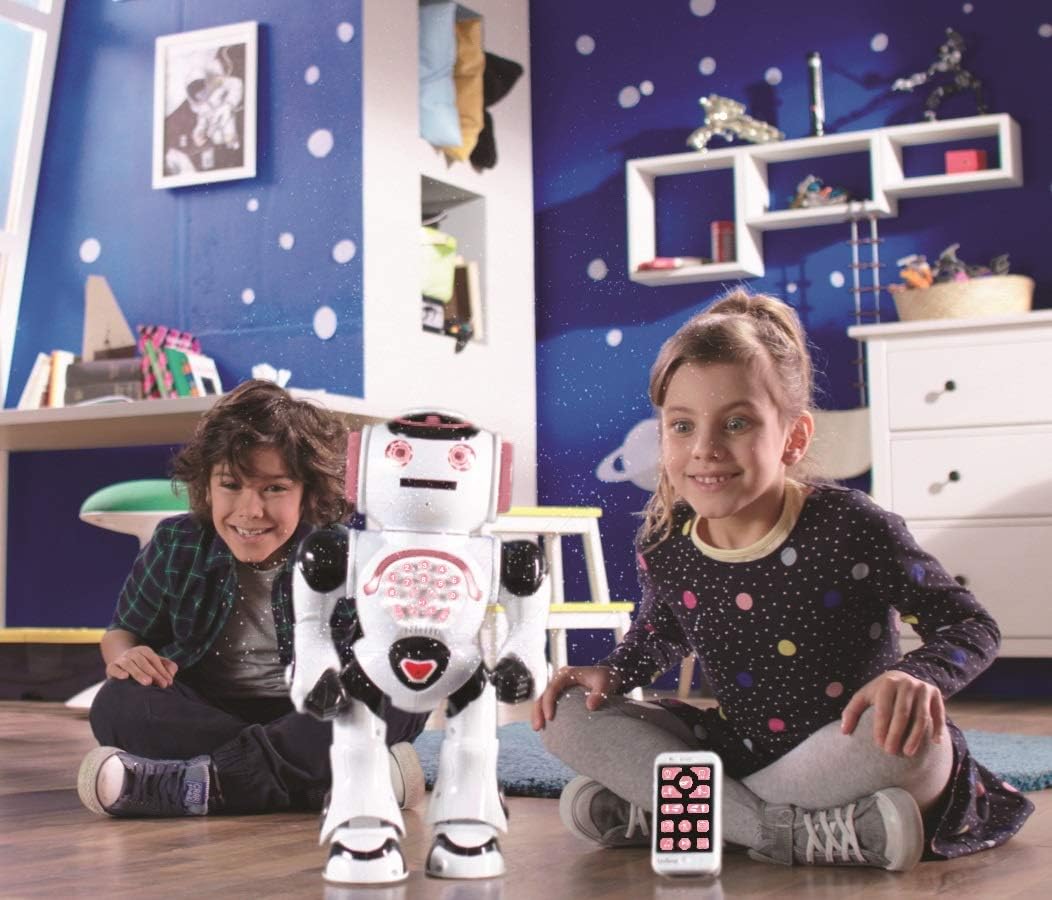 Two children playing with the Powergirl robot in a room