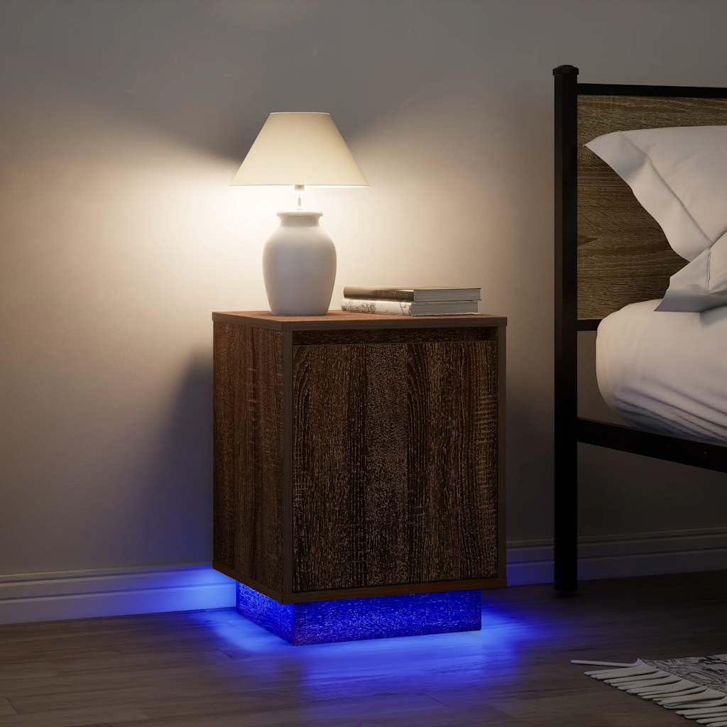 Szafka nocna z oświetleniem LED RGB, brązowy dąb, 38x34x50 cm, z drewnopochodnego materiału odpornego na wilgoć. Posiada dużo miejsca do przechowywania książek i szklanek, solidny