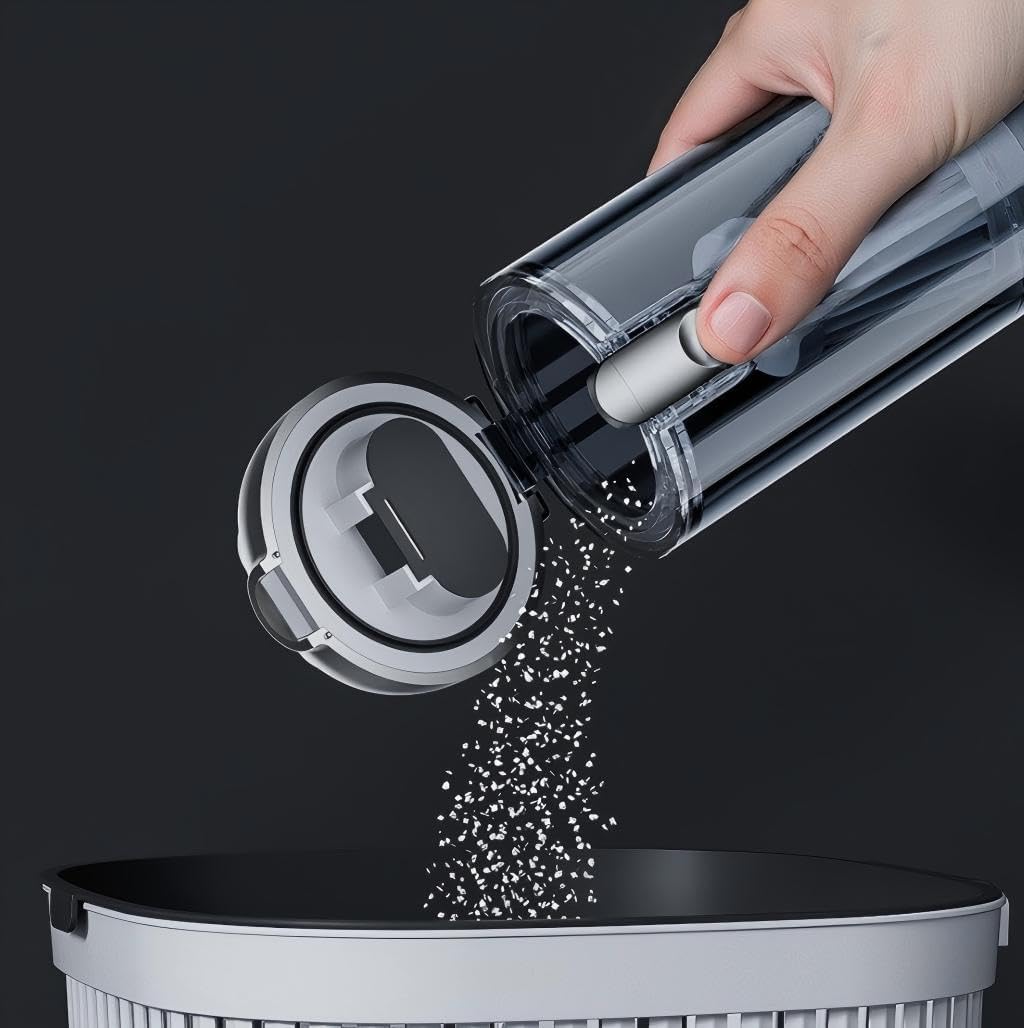 Hand emptying the dust bin of the ST-6691Plus vacuum cleaner into a trash can.