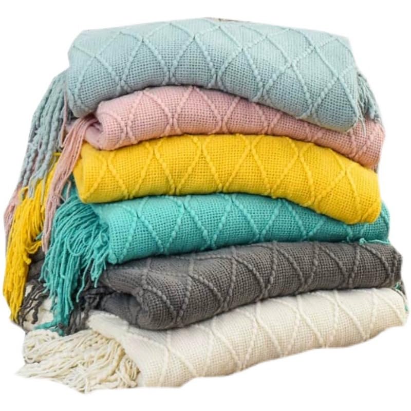 Jeté de canapé tissé d'exception avec pompons pour décoration raffinée