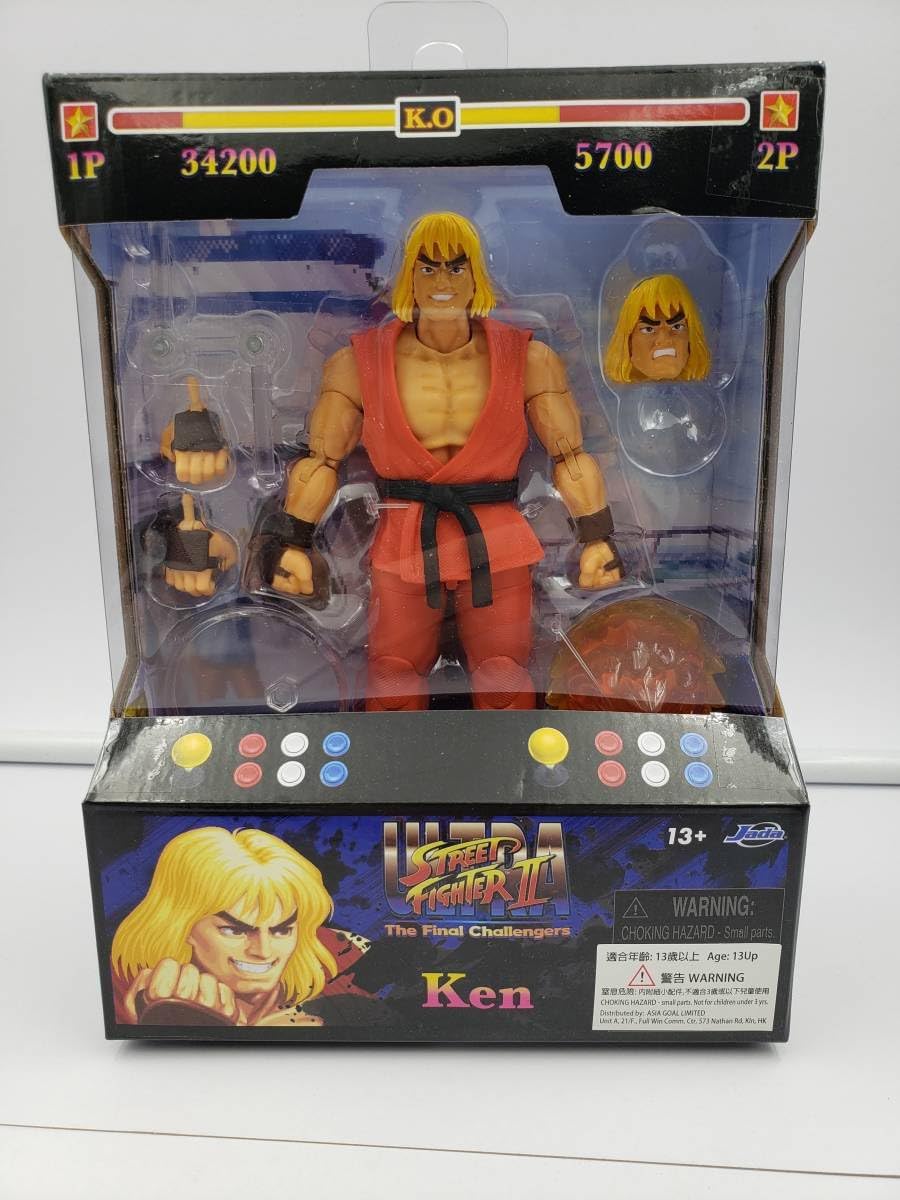 Entra En El Mundo De Street Fighter II Con La Figura De Acción Ultra Street Fighter II Guile (Player 2 Version) A Escala 1:12 De Jada Toys. Esta Figura De Acción Coleccionable