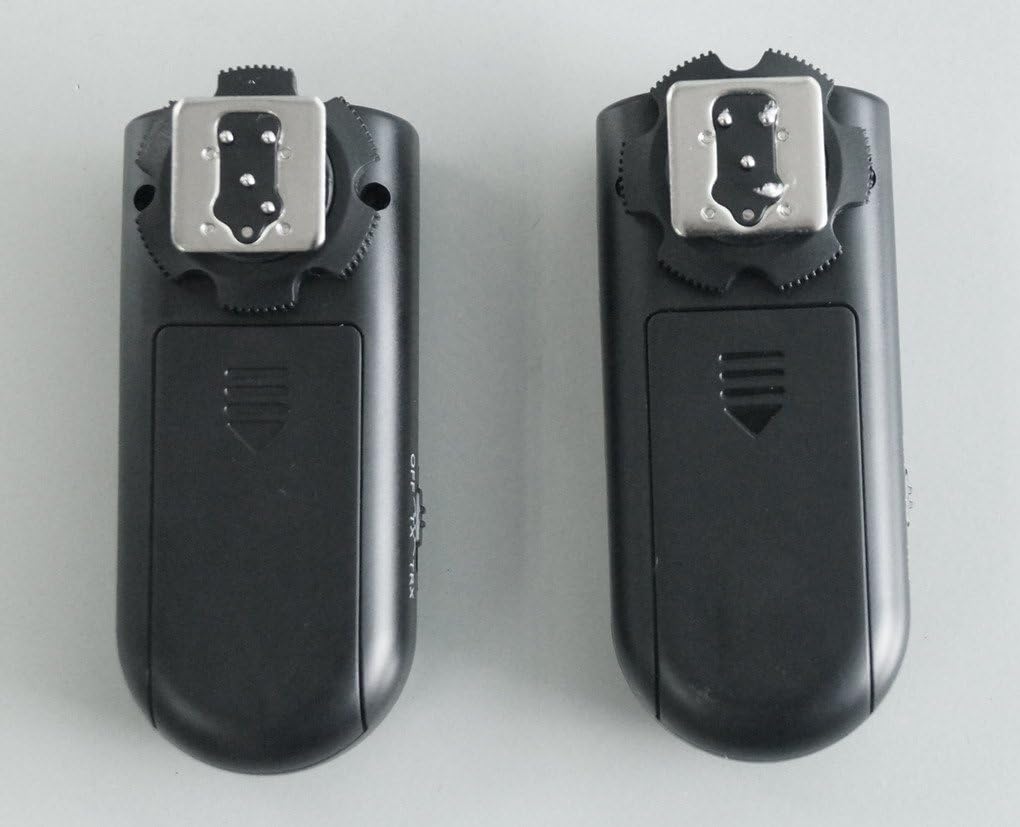 Front view of two Yongnuo RF-603 transceivers, showing hot shoe and shutter button