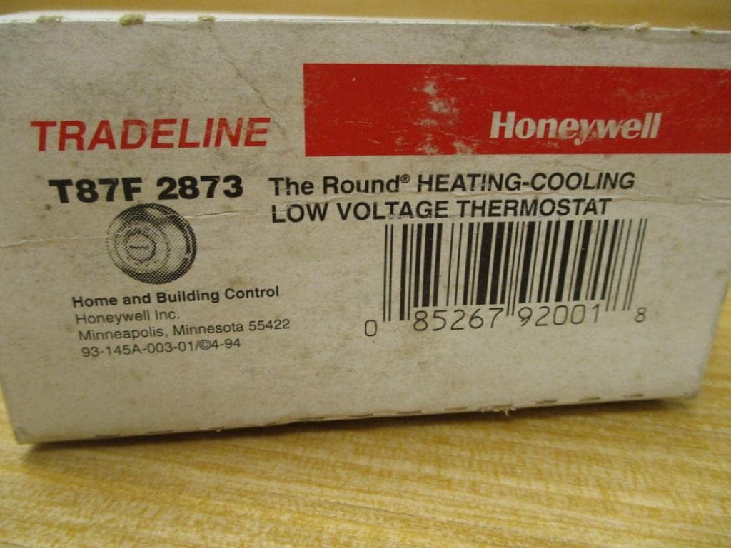 Close-up of Honeywell T87F 2873 Thermostat packaging showing model number and UPC.