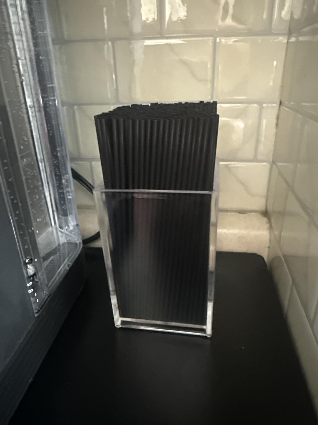 Makeup brushes stored upright in a clear holder