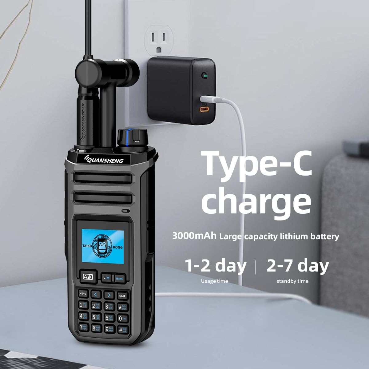 Quansheng TK-118 radio connected to a Type-C charger plugged into a wall outlet.