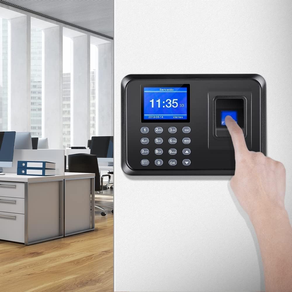 An employee's finger being placed on the fingerprint sensor of the time clock in an office environment.