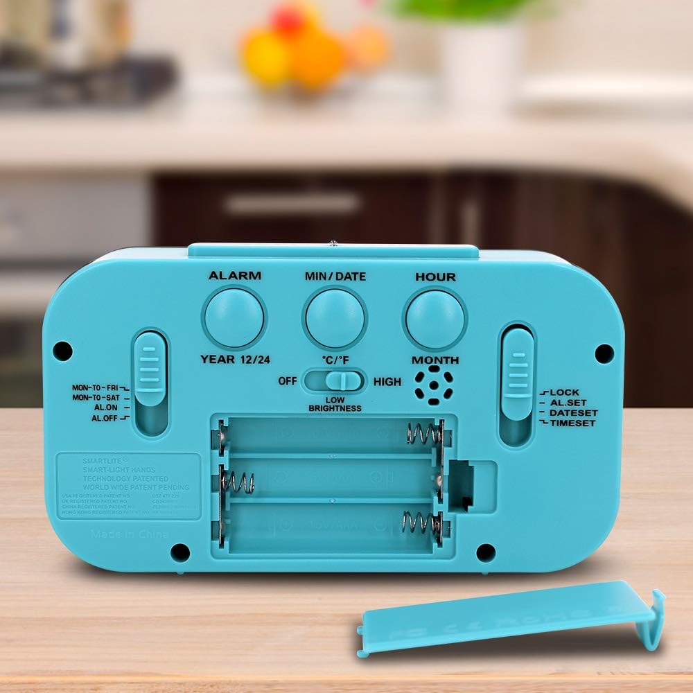 Z powrotem view of the Peakeep Digital Alarm Clock showing the battery compartment and control buttons.