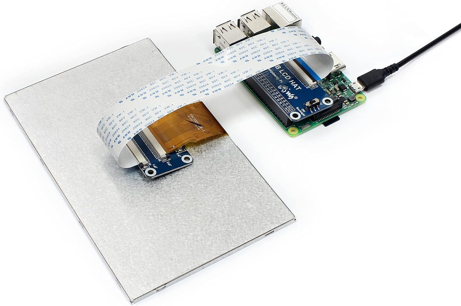 Image of the 7-inch DPI Display connected to a Raspberry Pi via the RGB LCD HAT, with a power cable attached to the Pi.