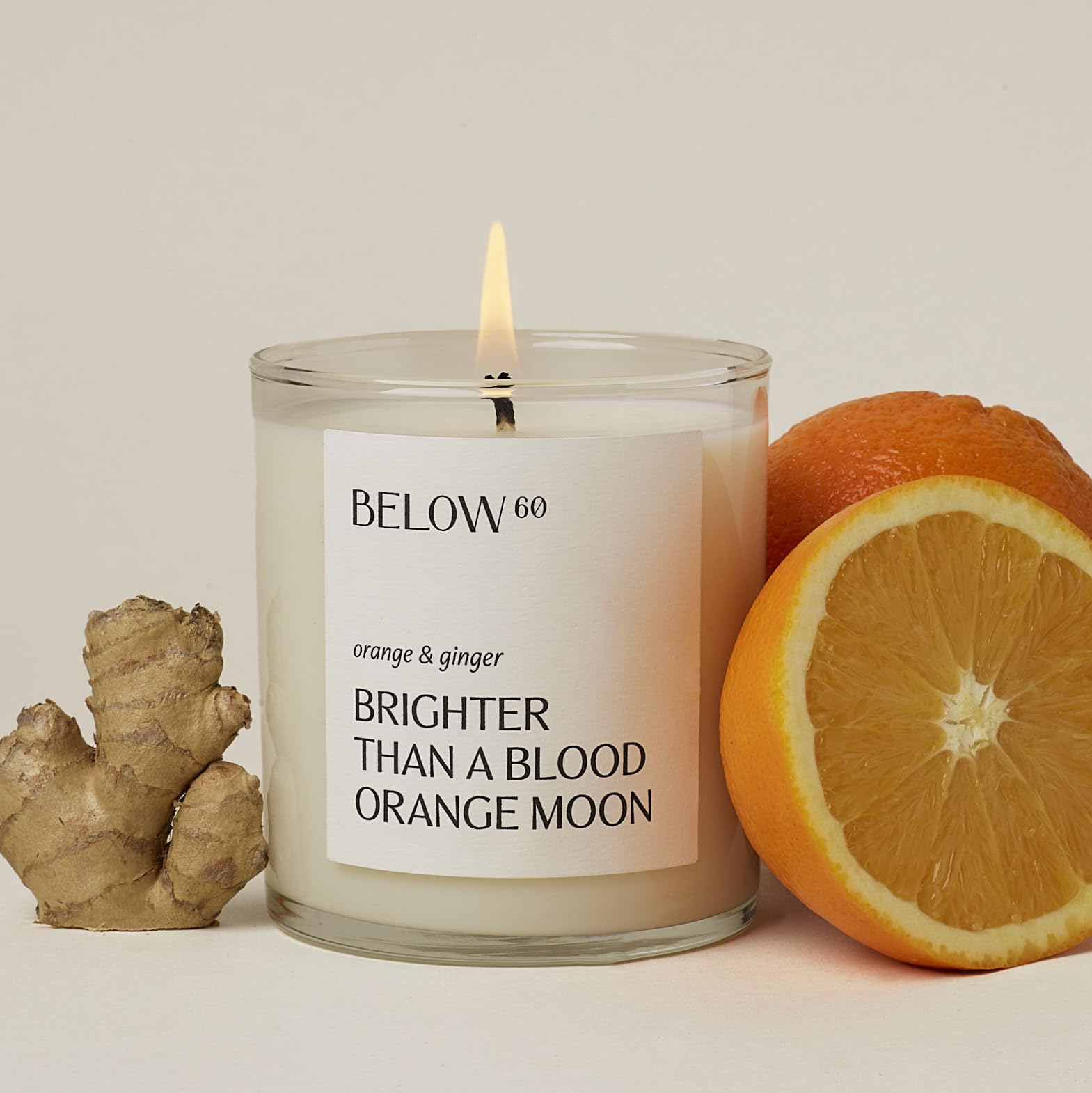 Below 60 Scented Candle – Brighter Than A Blood Orange Moon – Essential Oil-Based – Hand-Made with Paraffin-Free Soy Wax – 100% Cotton Wick – 50 hr Burn Time - by Hilary Duff – Orange & Ginger (10oz)