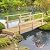 7' Wooden Garden Bridge with Safety Rails, Rustic Footbridge for Ponds, Creeks, Streams, and Walkways, Natural Wood Finish, Outdoor-Ready, Max Load 396 lbs, 84.75" L x 28.75" W x 21.75" H