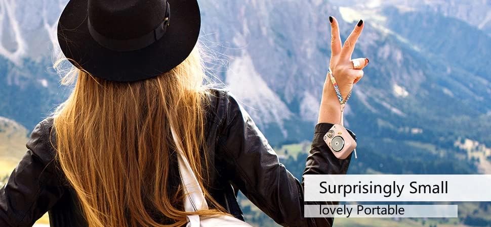 Person holding a pink Divoom Beetles speaker