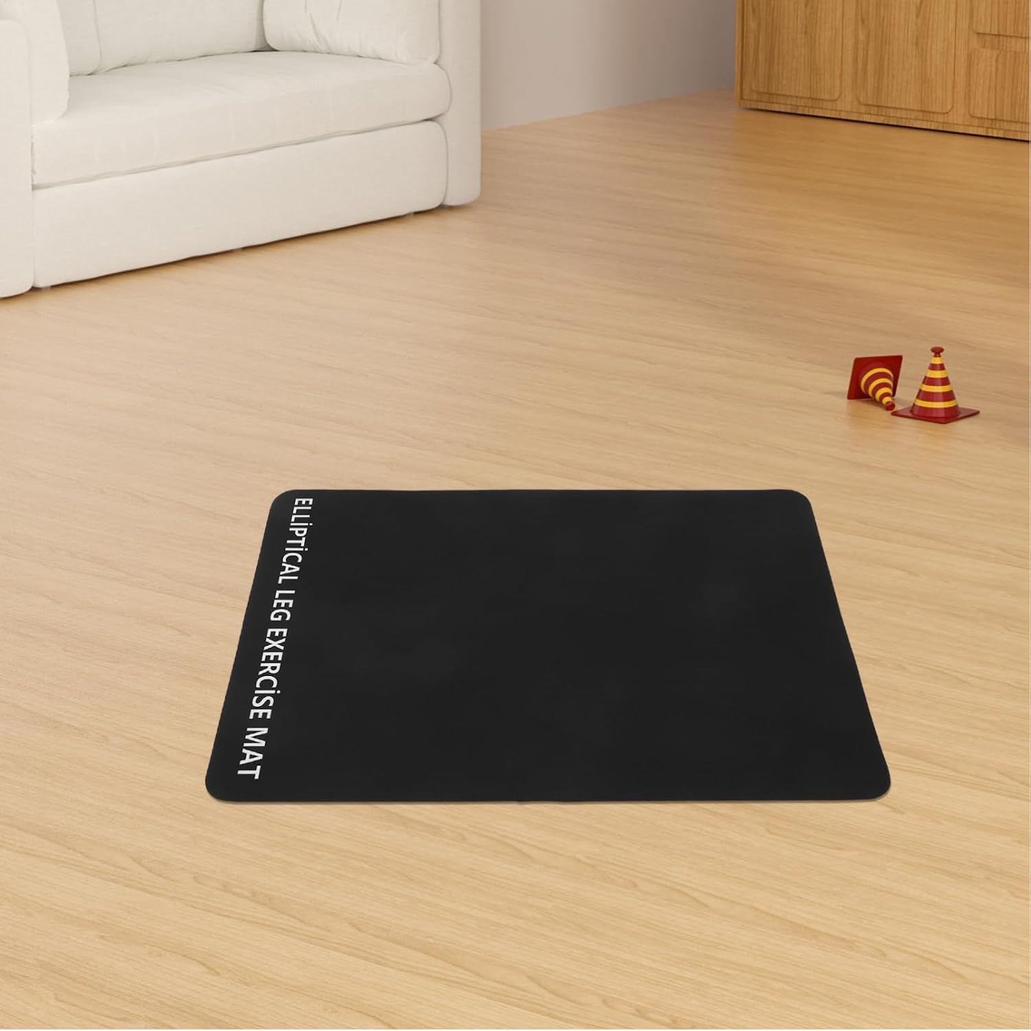 Anneome Anti-Vibration Treadmill Mat placed on a wooden floor in a room.