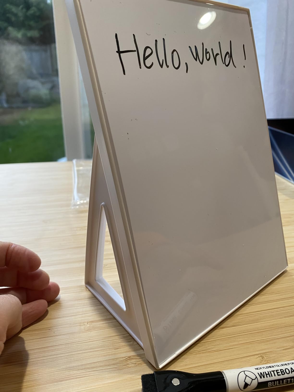 small easel whiteboard with the words Hello World written on it