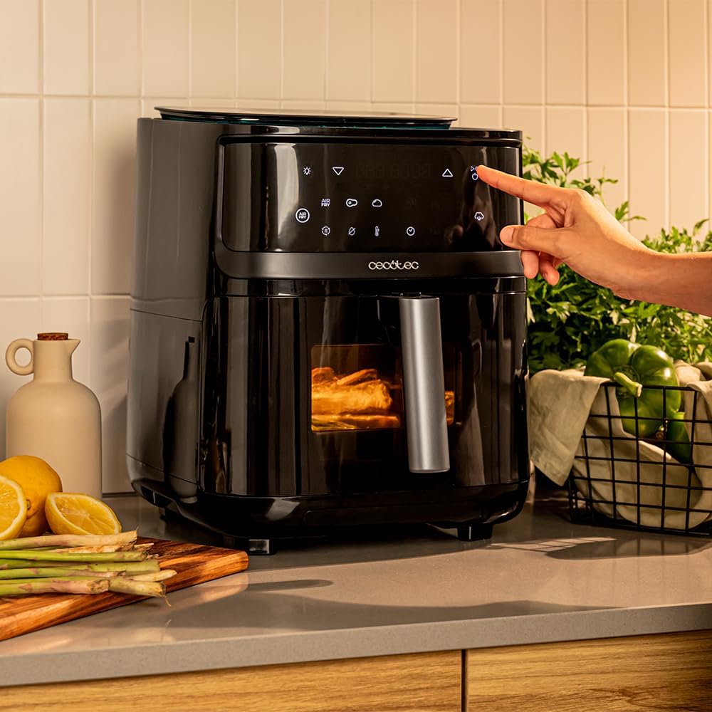 Person interacting with the touch control panel of Cecofry Mist 7000 Air Fryer