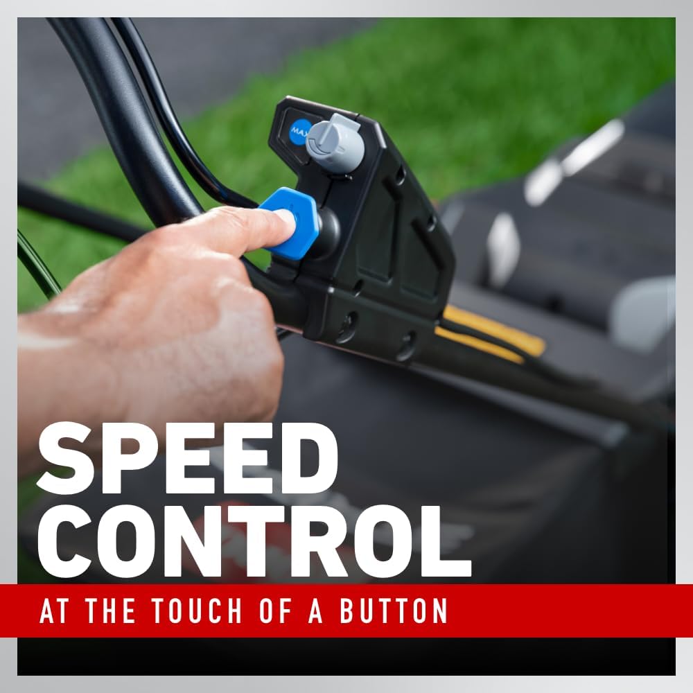 Close-up of a hand pressing the speed control button on the mower handle.