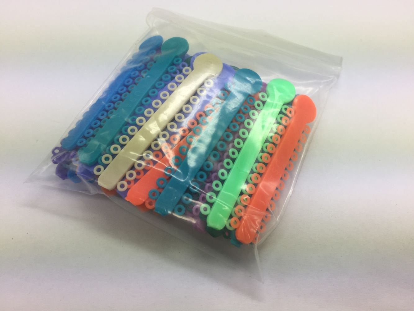 SDent® 10 Packs = 1008pcs Dental Orthodontic Ligature Tie Elastic Rubber 24 * 42 per Pack Color Mixed Randomly
