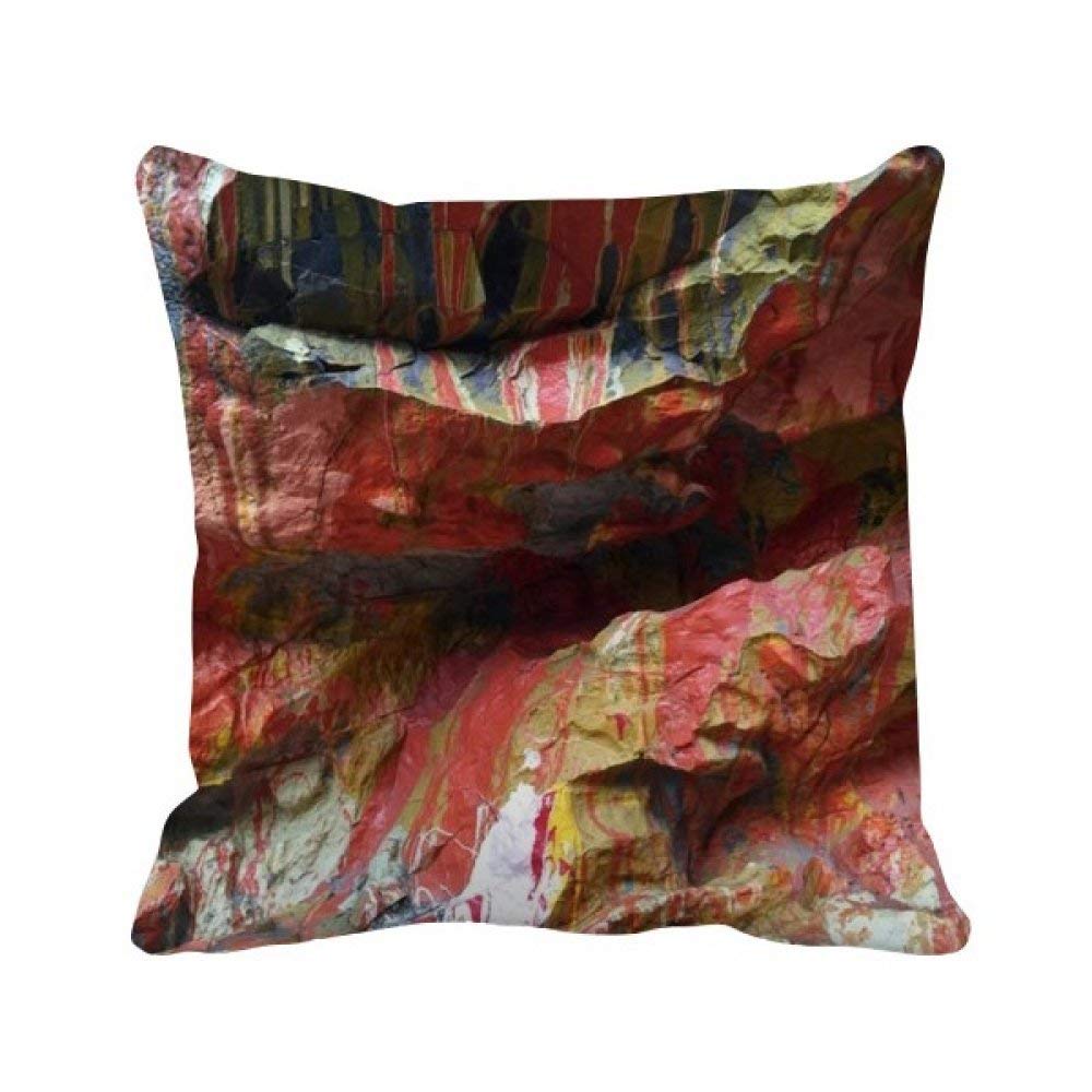 Housse de coussin carrée texture pierre multicolore idéale sur un canapé en lin