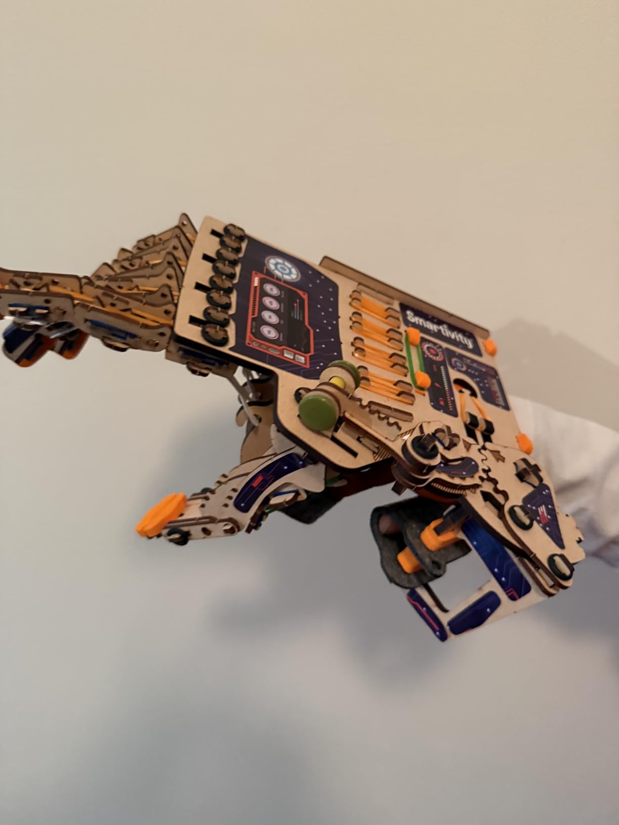 Close up of the Smartivity mechanical hand showing the wooden gears and linkage system that control finger movement