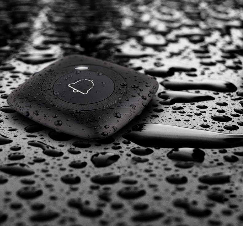 Close-up of a waterproof call button with water droplets, demonstrating its durability.