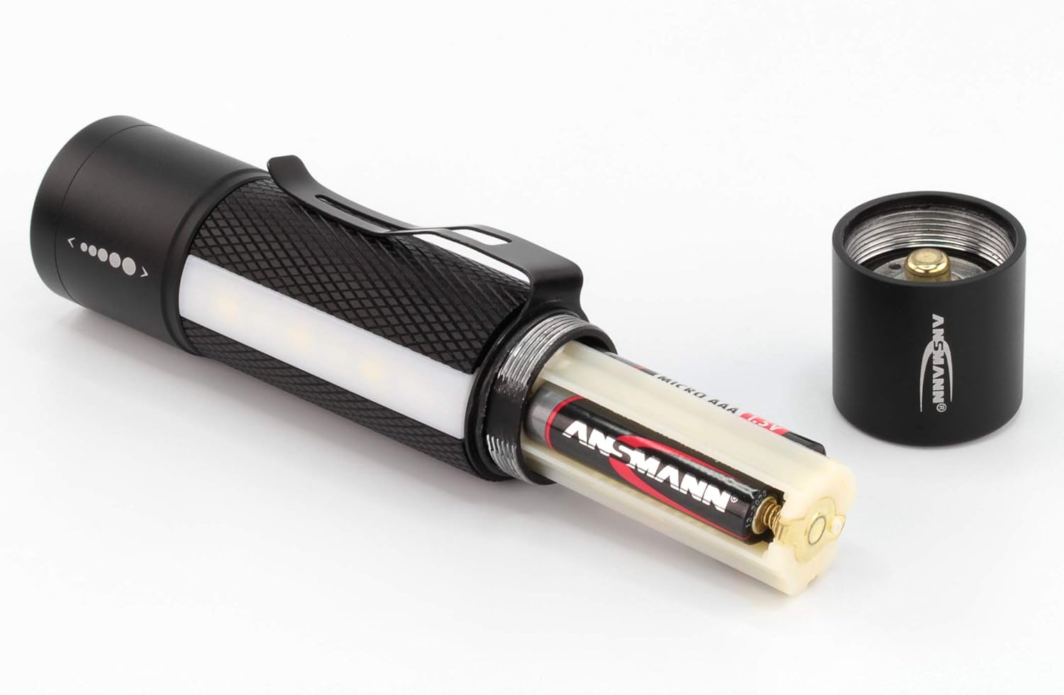 ANSMANN Future 3in1 LED Flashlight next to three AAA batteries.