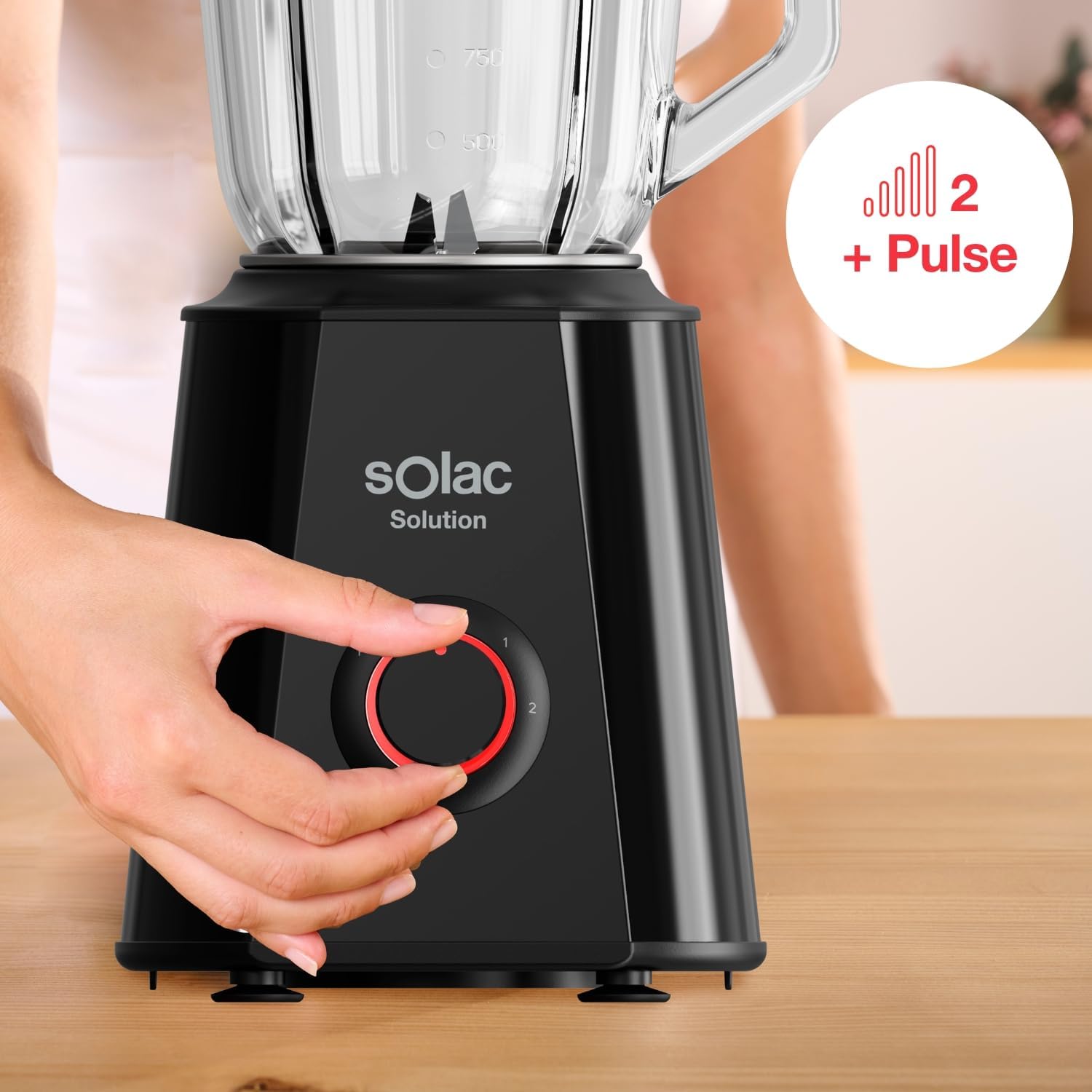 A hand adjusting the speed dial of the Solac Solution BV6785 Blender, showing options for 2 speeds and pulse function
