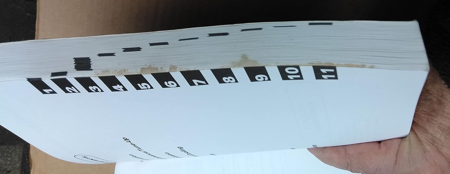 Side view of the service manual showing numbered section tabs