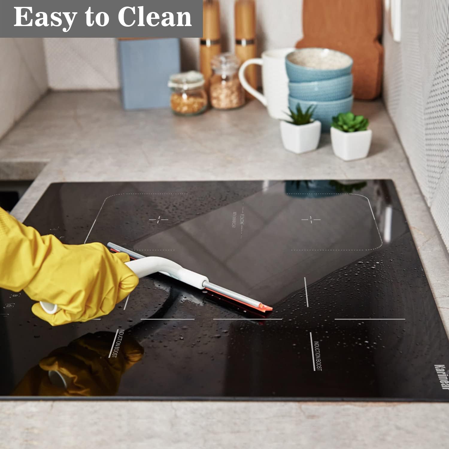 Person cleaning Karinear Induction Hob with a scraper