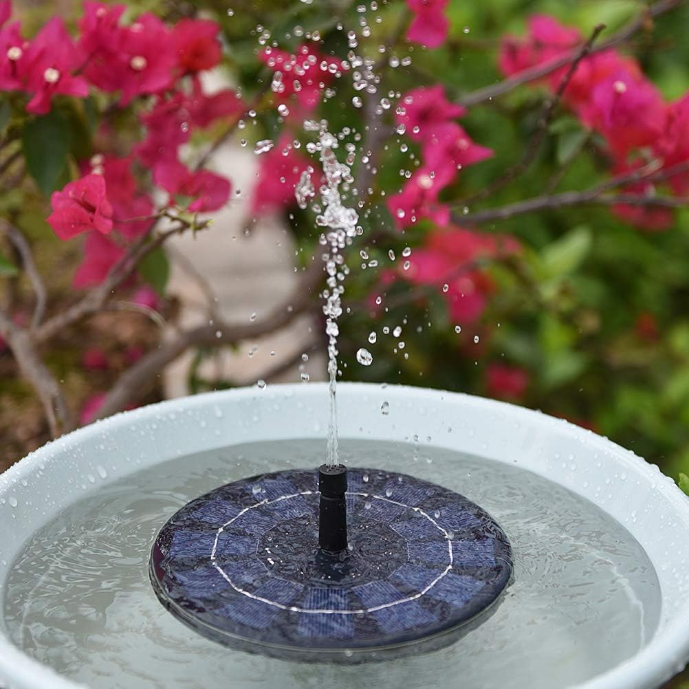Ankway solar fountain pump floating in a bird bath, spraying water.