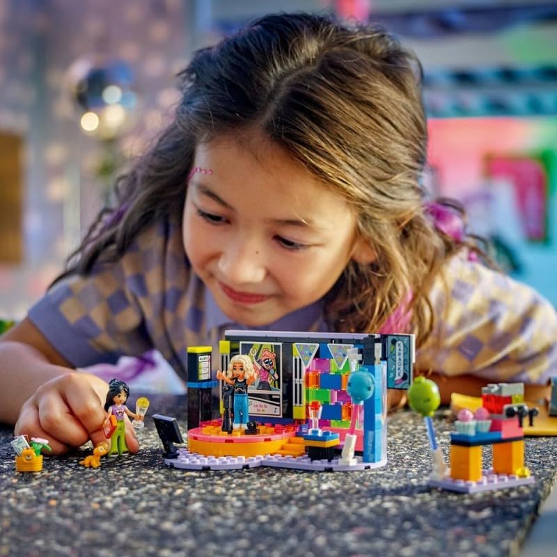 LEGO Friends Karaoke Music Party Set in action, showing a mini-doll on the revolving stage and another at the snack bar.