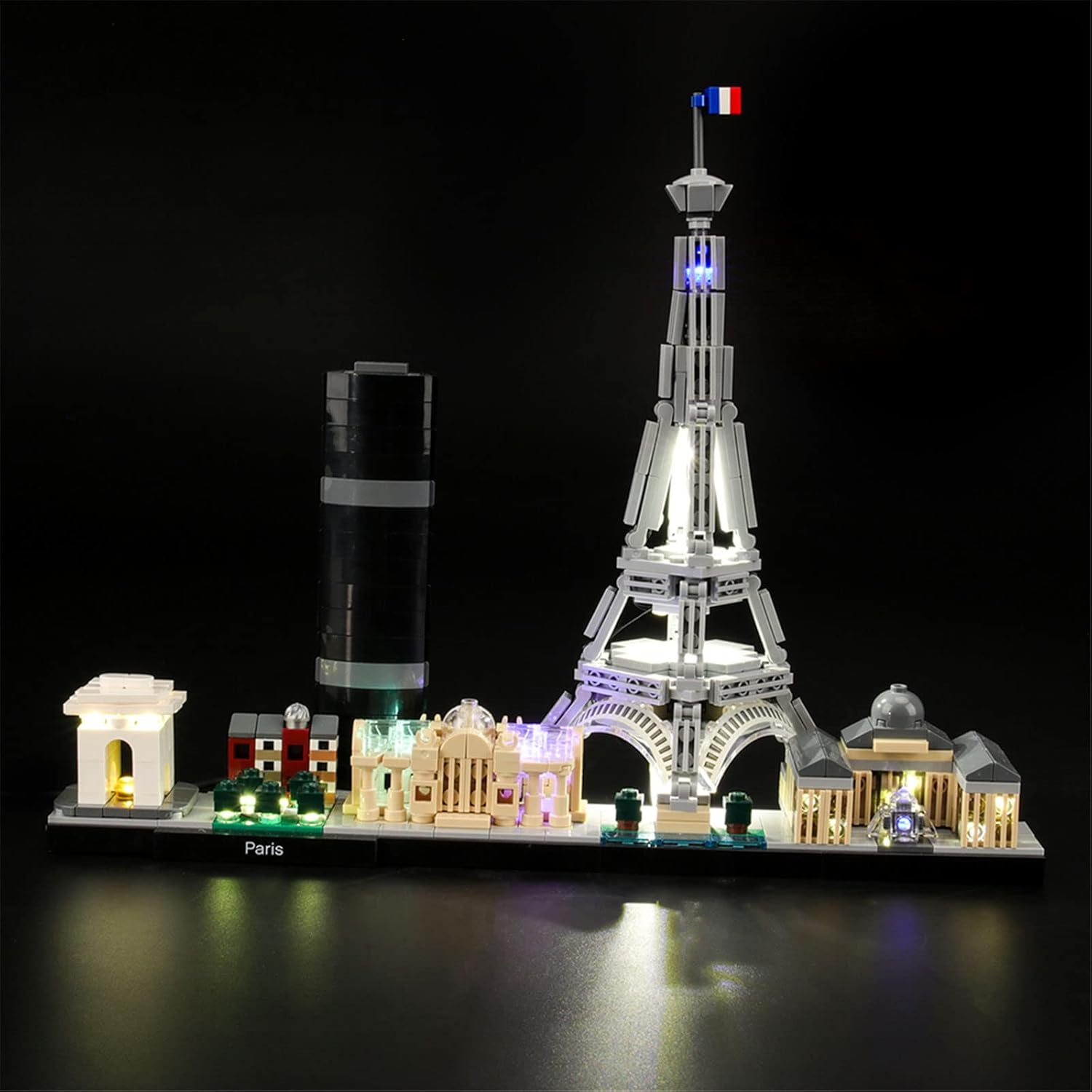 LIGHTAILING LED lighting kit installed on a Lego Architecture Paris model, showing the Eiffel Tower and other landmarks illuminated against a dark background.