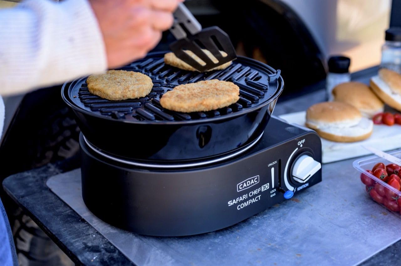 Close-up of burgers grilling on the BBQ grid of the Cadac Safari Chef 30.