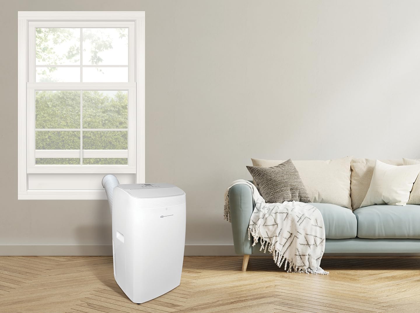 Portable air conditioner unit installed with window kit in a room