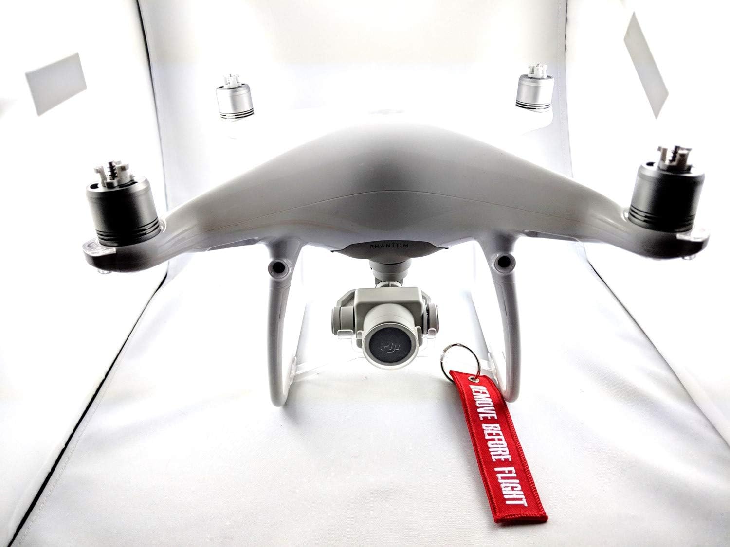 Davant view of the DJI Phantom 4 Advanced Drone with a 'REMOVE BEFORE FLIGHT' tag on the gimbal.