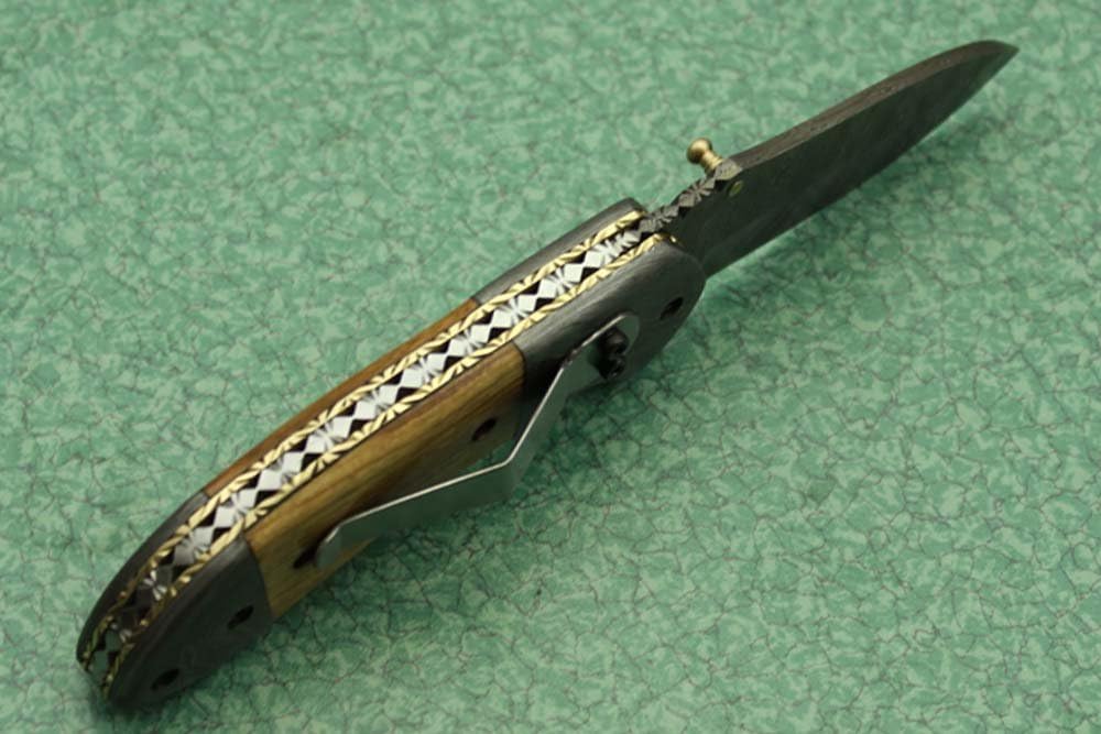 7 Inch Long Hand Forged Damascus Steel Folding Knife, Natural Wood, Camel Bone, Bull & Ram Horn Scales with Damascus Bolster, Equipped with Liner Lock and Thumb knob, Cow Hide Leather Sheath
