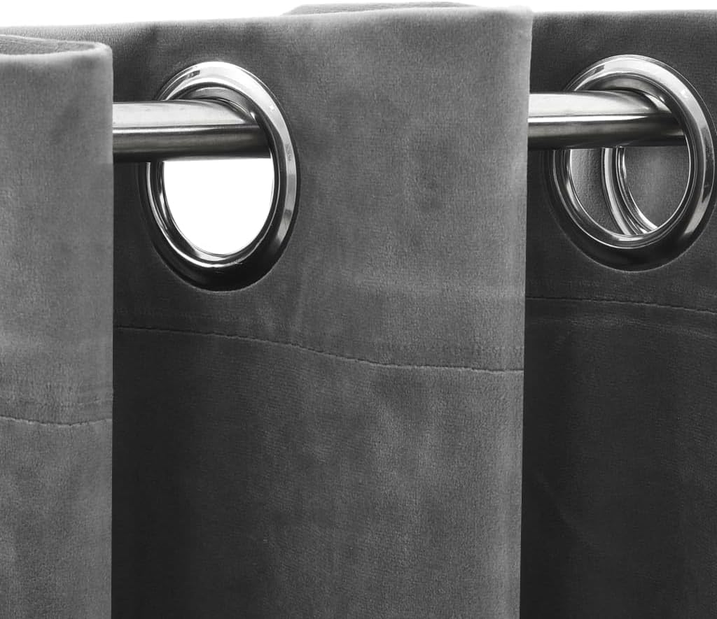 Close-up of the metal grommet rings on the grey velvet curtain.
