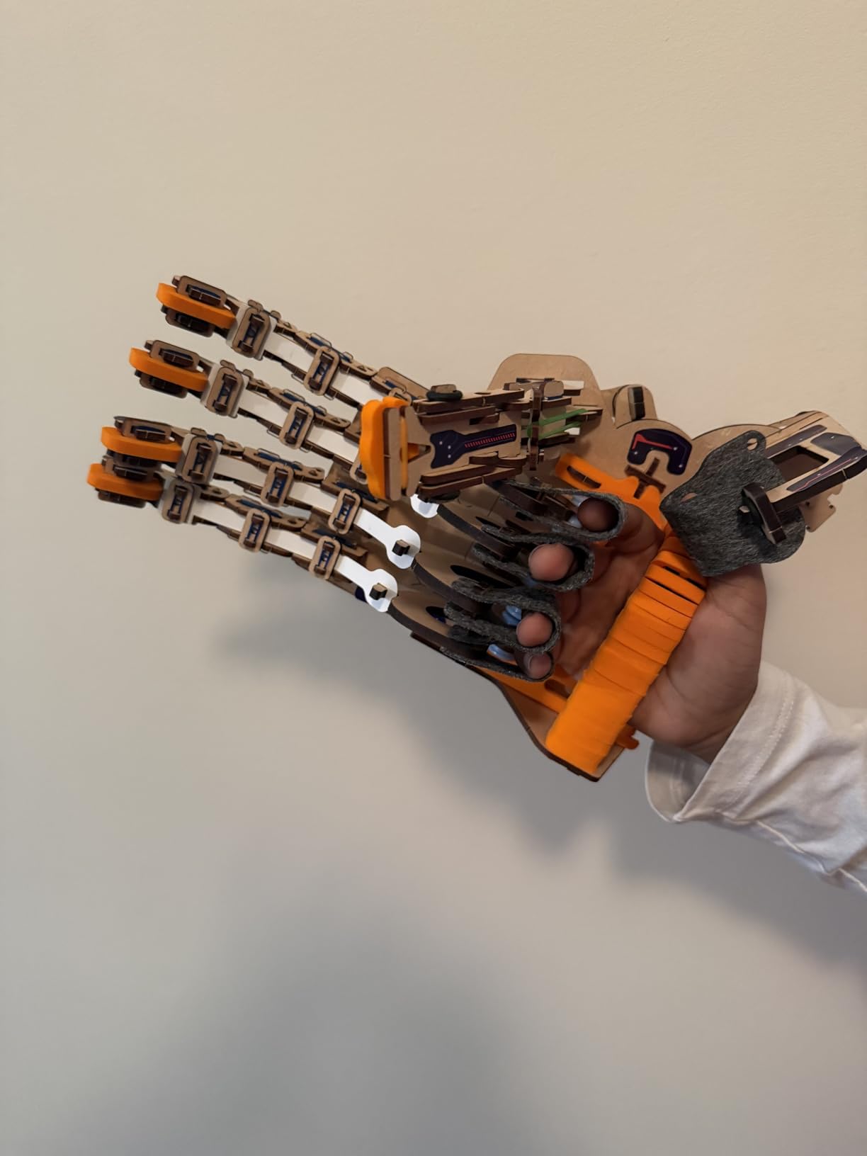 Smartivity DIY Robotic Mechanical Hand showing the completed wooden mechanical hand with fingers extended