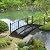 Outsunny 7' Metal Arch Garden Bridge with Safety Siderails, Decorative Arc Footbridge with Delicate Scrollwork S Motifs for Backyard Creek, Stream, Fish Pond, Black