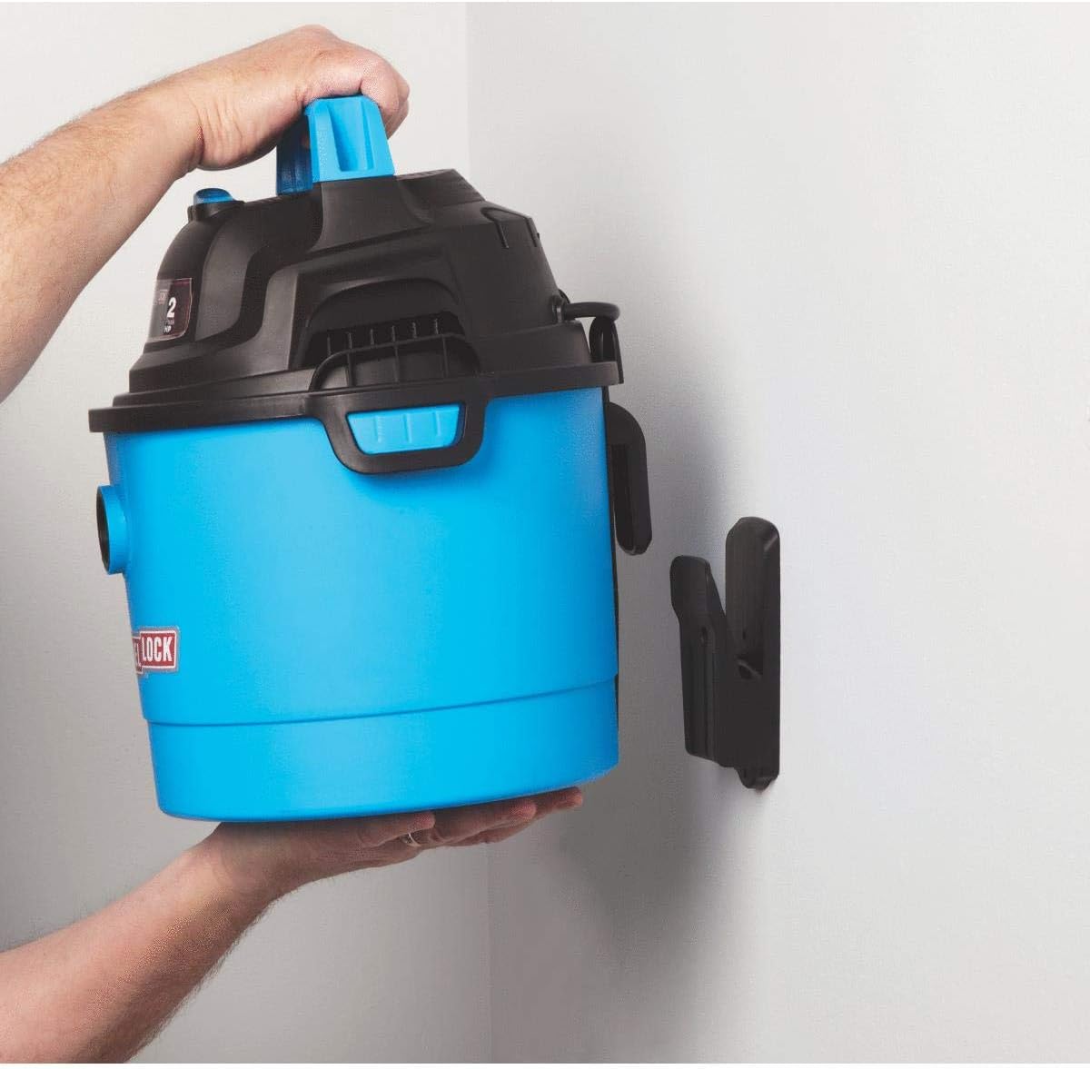 Person mounting the Channellock 2.5 Gallon Wet/Dry Vacuum onto a wall bracket