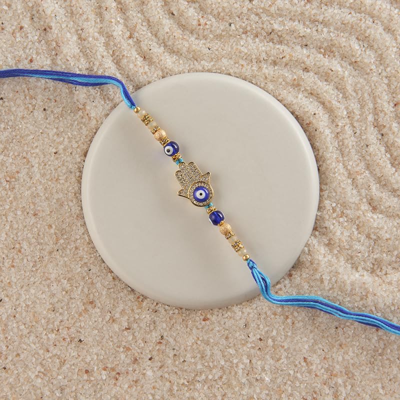 Image of THE GIFT STUDIO.COM | Premium Zircon Hamsa Hand Evil Eye Rakhi for Brother | Handmade Designer Rakhi | Blue & Gold Raksha Bandhan Thread |