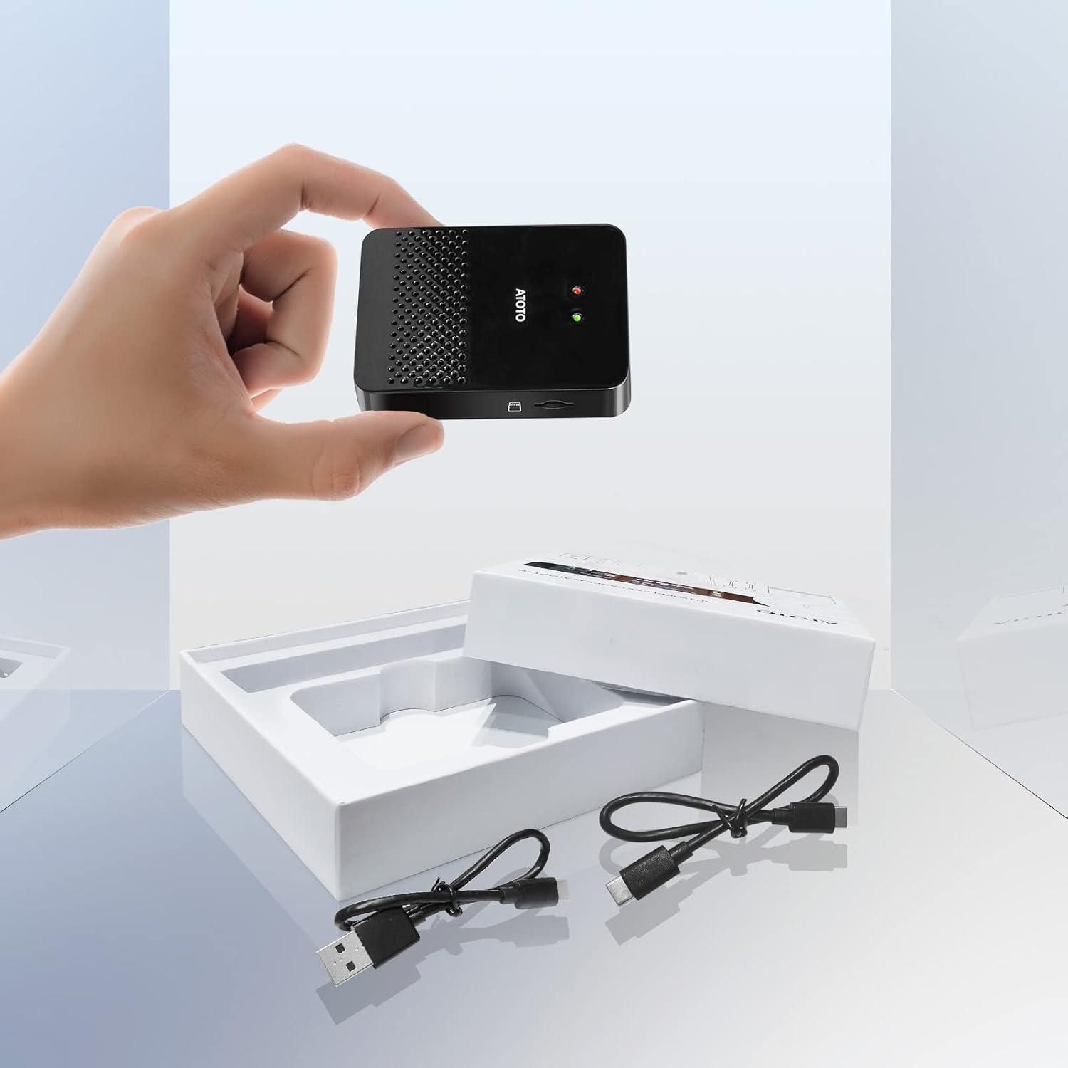 Contents of the ATOTO AD3-B package, including the adapter and two USB cables.