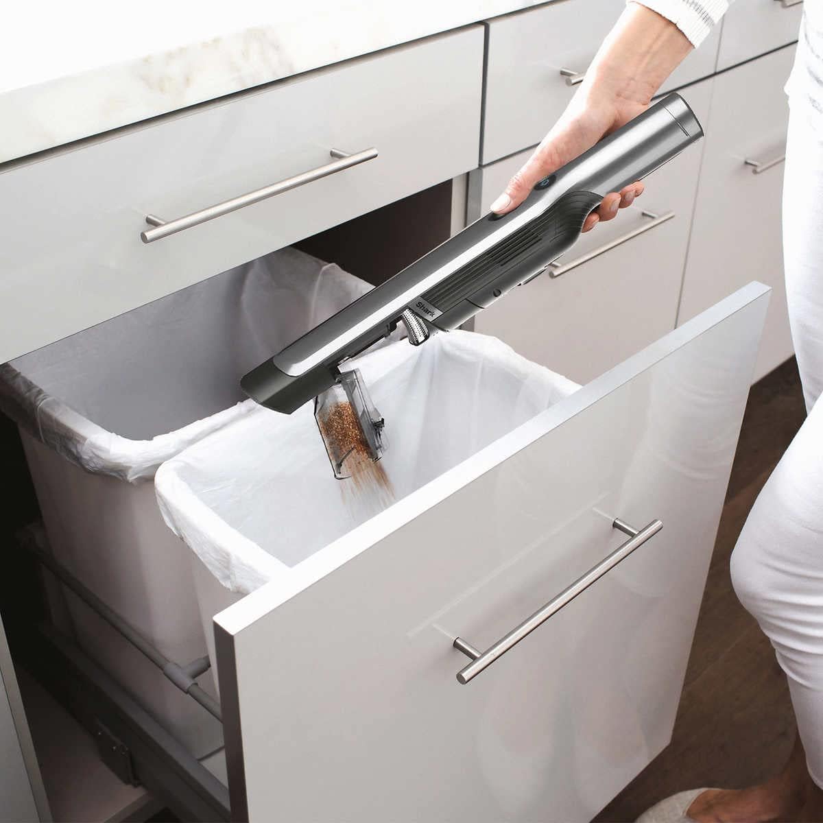 Vacuum cleaning kitchen counter.