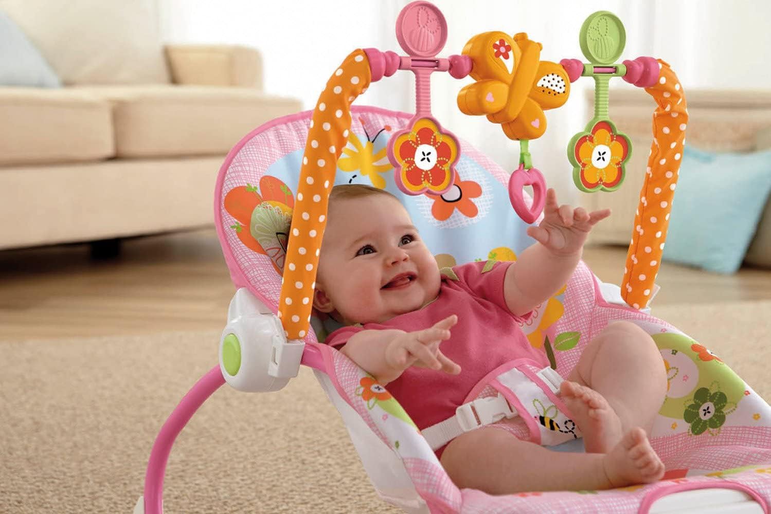 Infant interacting with the toy bar on the rocker